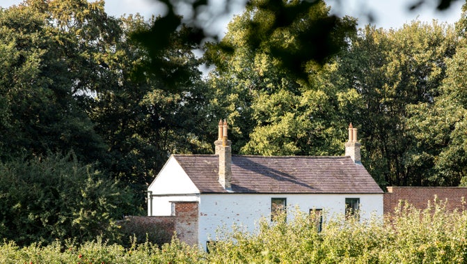 A view of the garden cottage across the Walled Garden in Summer at Gibside